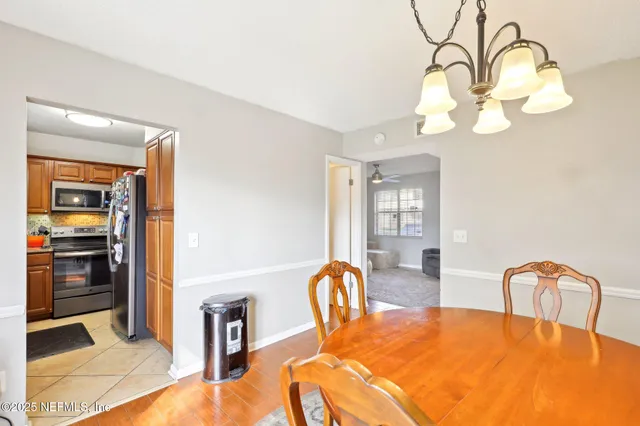 a dining room with furniture and chandelier