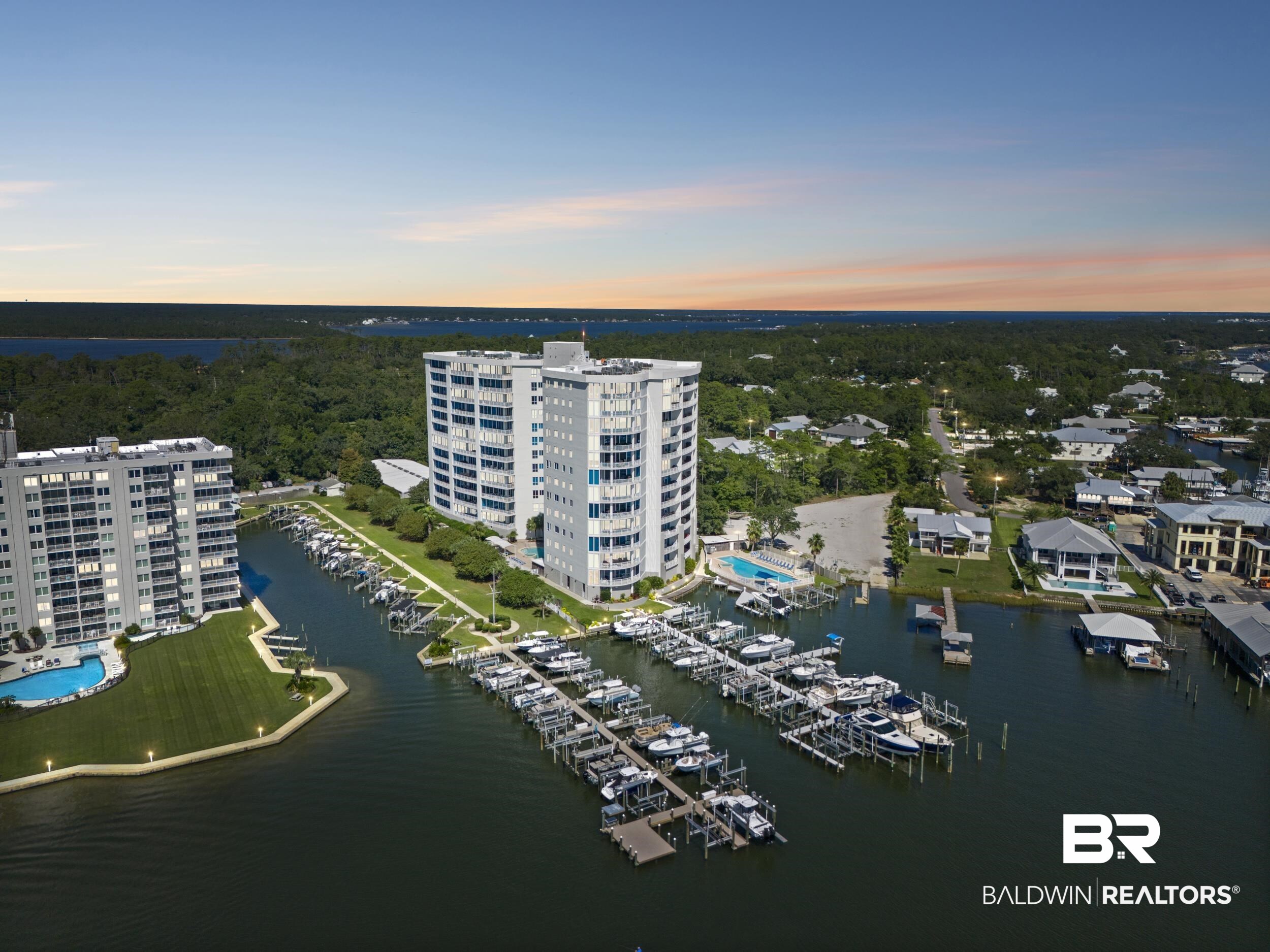 28250 Canal Road, Unit 307 Orange Beach, AL 36561 - Photo 54 of 56 Drone / aerial view of a large body of water and apartment complex / building