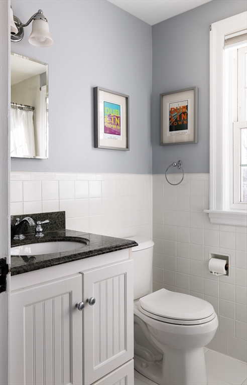 23 Regina Road Newton, MA 02466 - Photo 22 of 33 a bathroom with a granite countertop sink and a toilet