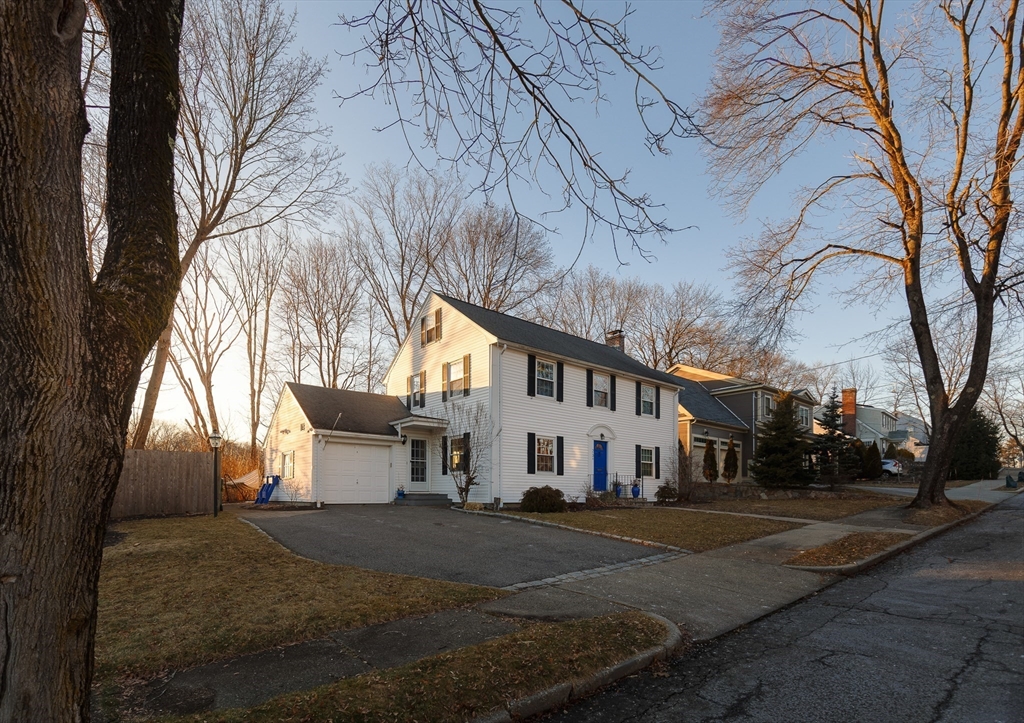 23 Regina Road Newton, MA 02466 - Photo 27 of 33 a view of a white house with a yard covered with snow