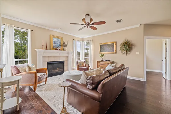 a living room with furniture and a wooden floor