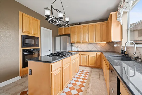 a kitchen that has a table and chairs in it