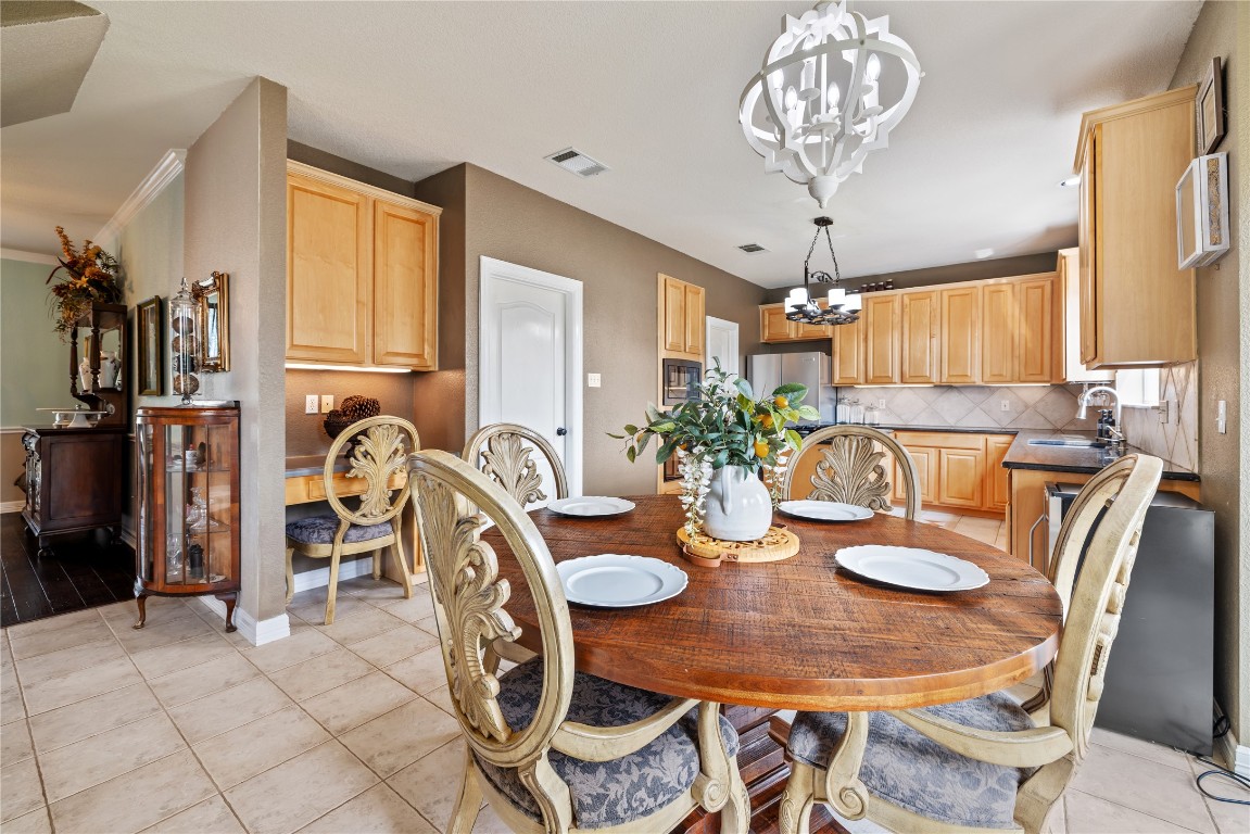 100 South Ridge Circle Georgetown, TX 78628 - Photo 16 of 37 Dining room with baseboards, a chandelier, light tile patterned floors, and visible vents