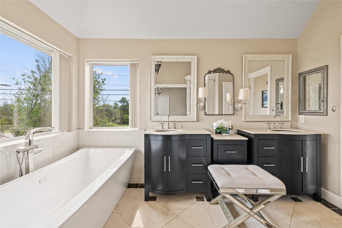 100 South Ridge Circle Georgetown, TX 78628 - Photo 27 of 37 Bathroom with a soaking tub and vanity