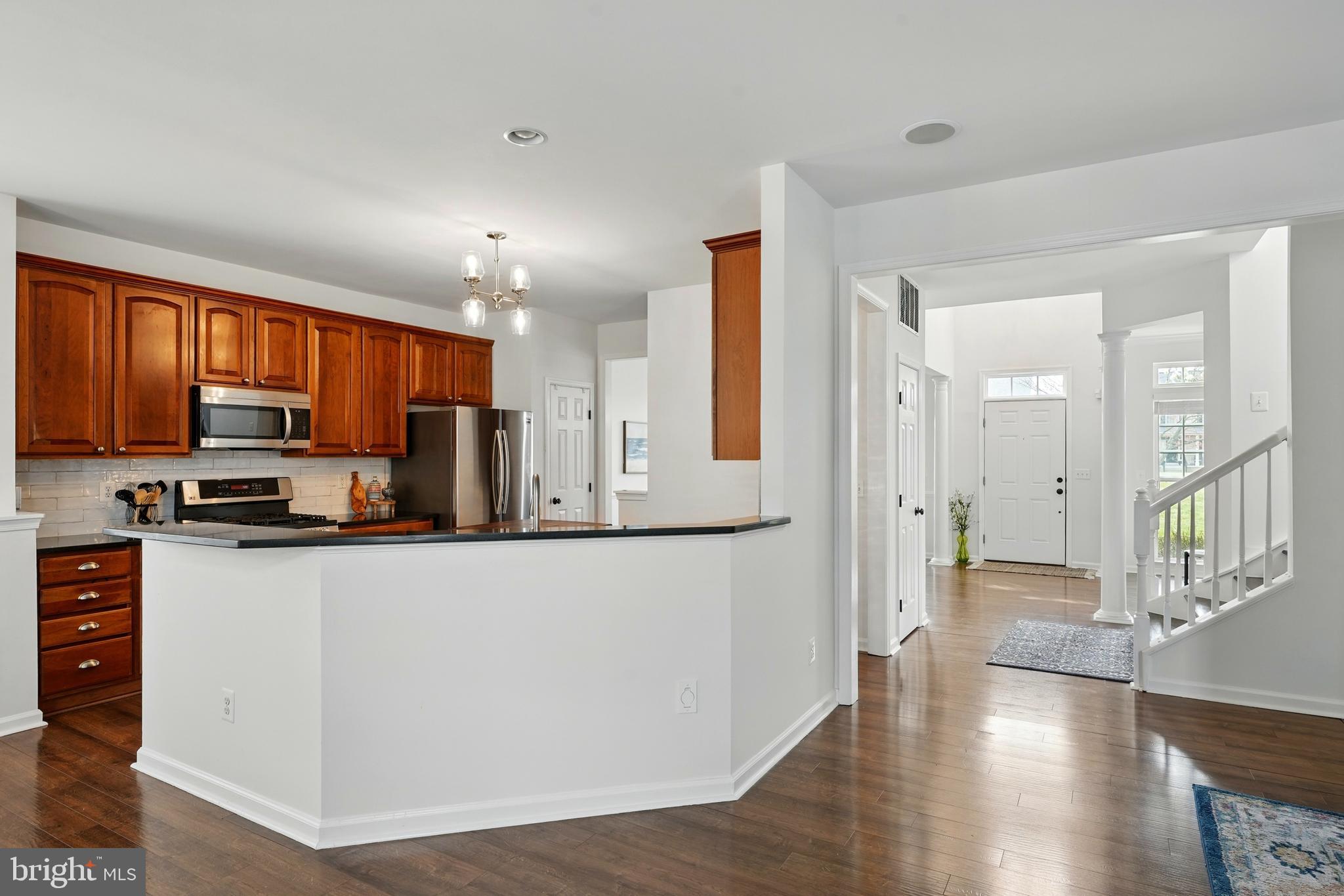 6712 Eldermill Lane Gainesville, VA 20155 - Photo 11 of 56 a large kitchen with stainless steel appliances granite countertop a refrigerator a stove top oven a sink and dishwasher