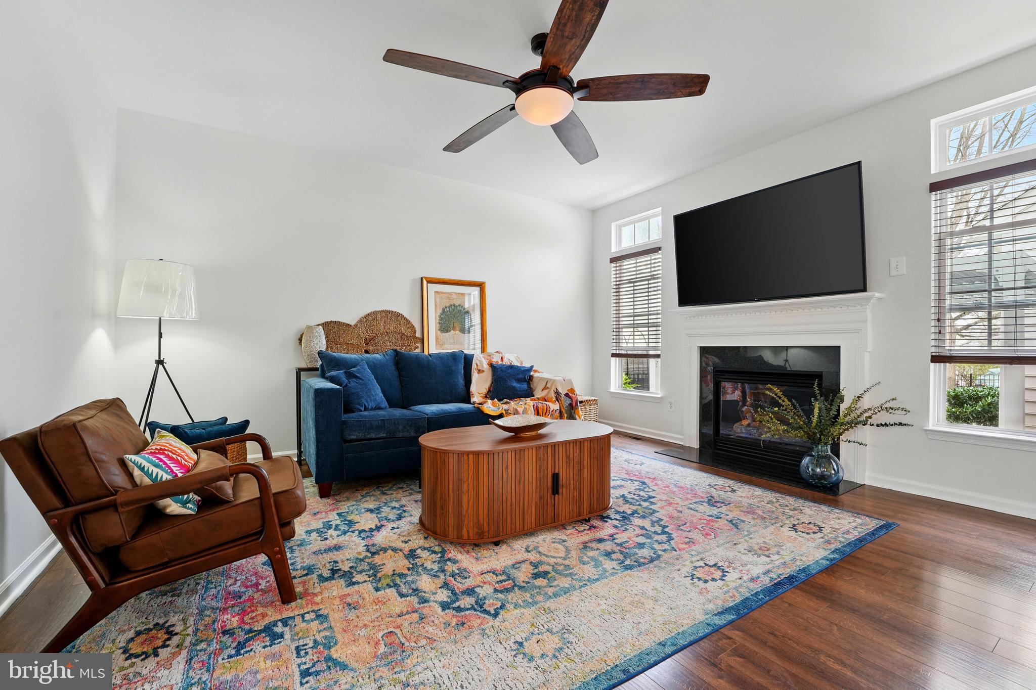 6712 Eldermill Lane Gainesville, VA 20155 - Photo 18 of 56 a living room with furniture a flat screen tv and a fireplace
