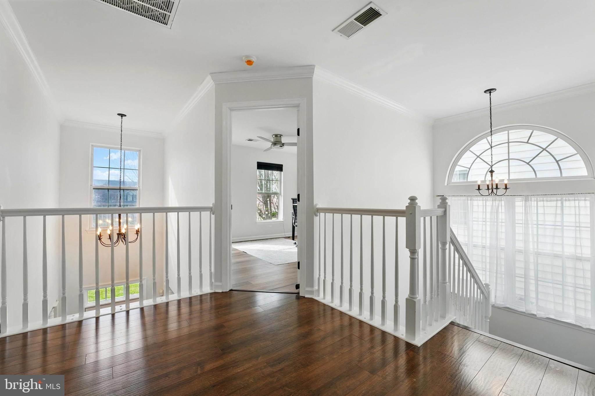 6712 Eldermill Lane Gainesville, VA 20155 - Photo 20 of 56 an empty room with wooden floor and windows
