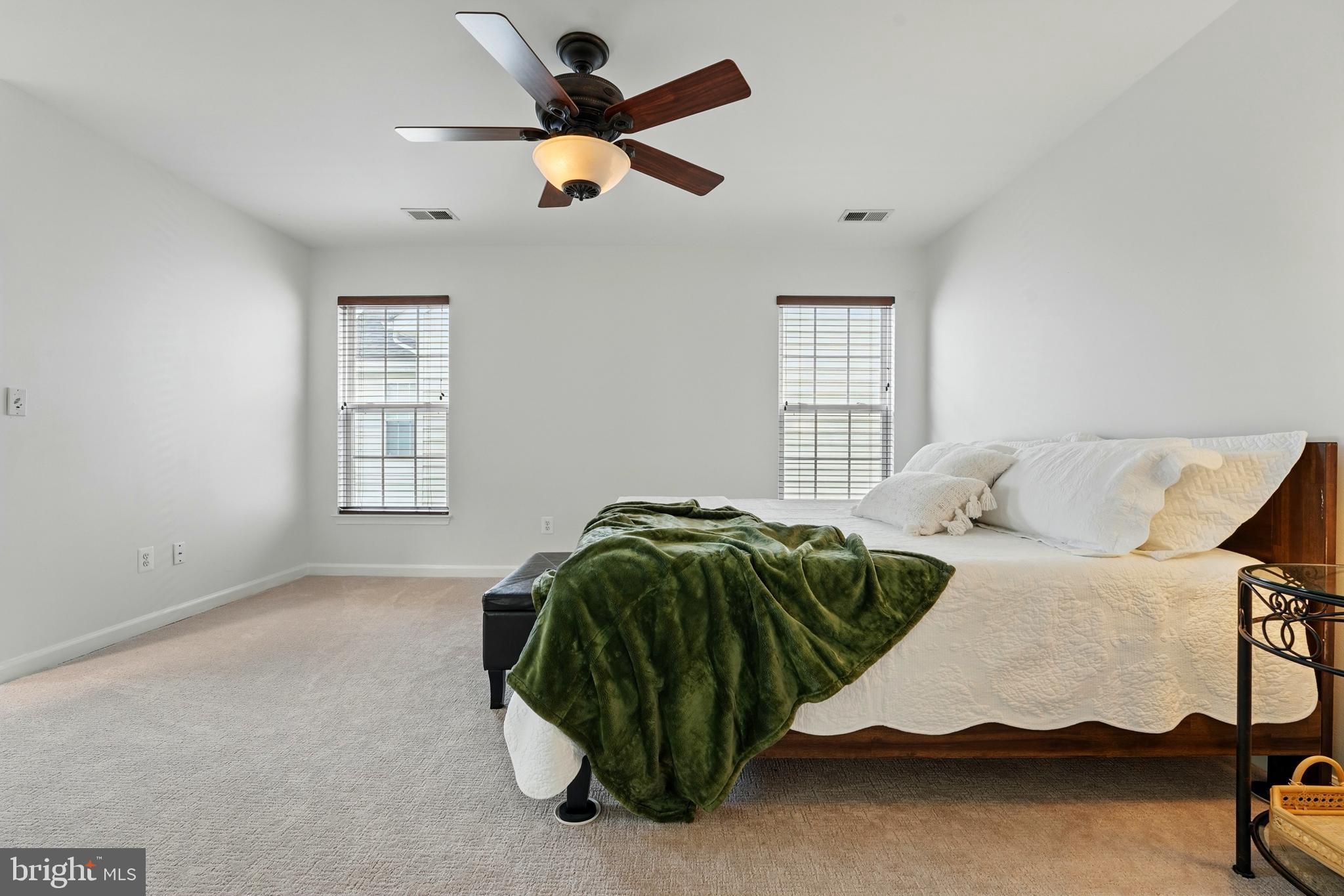 6712 Eldermill Lane Gainesville, VA 20155 - Photo 29 of 56 a bedroom with a bed and a ceiling fan