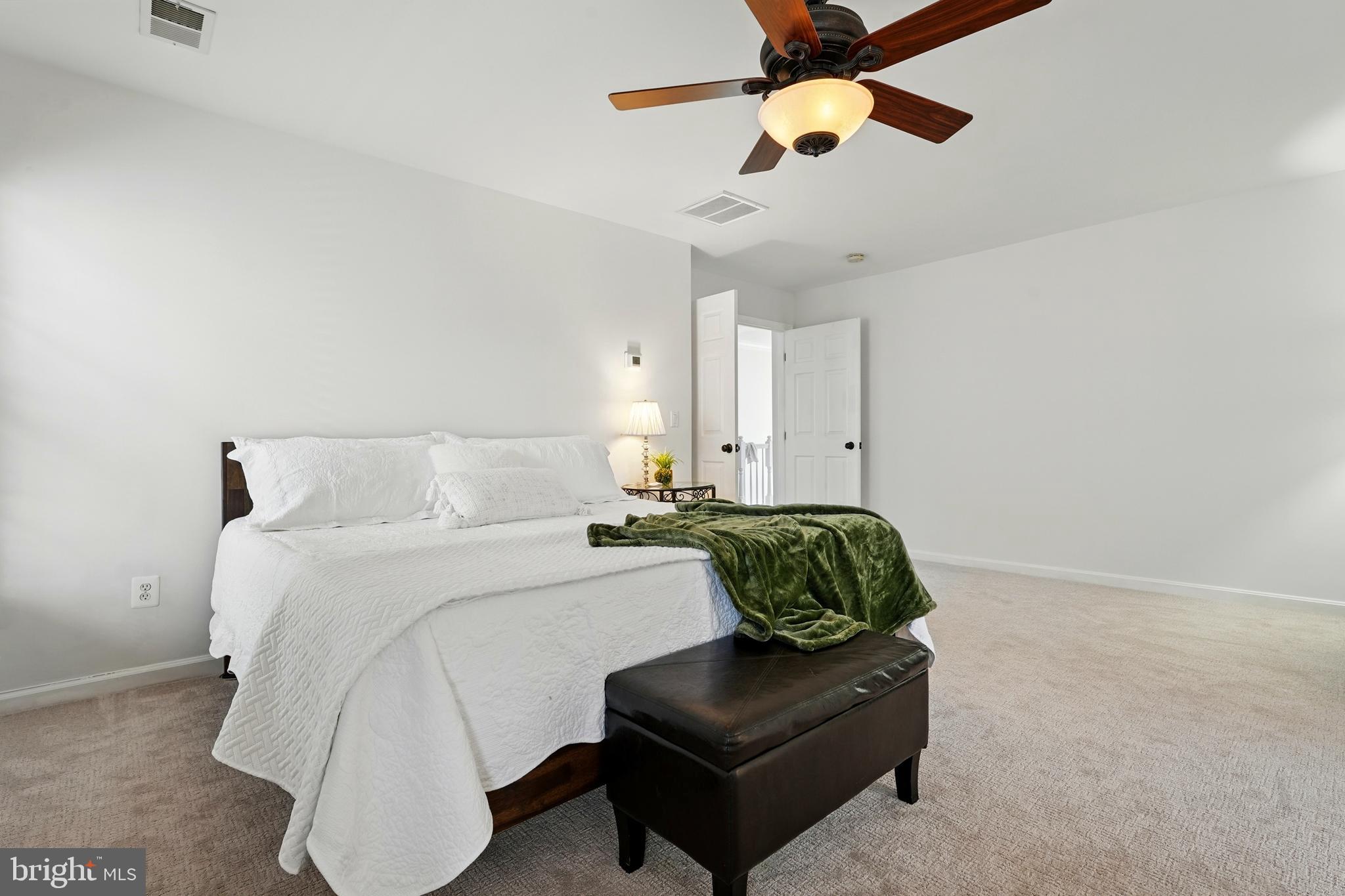 6712 Eldermill Lane Gainesville, VA 20155 - Photo 30 of 56 a bedroom with a bed couch and window