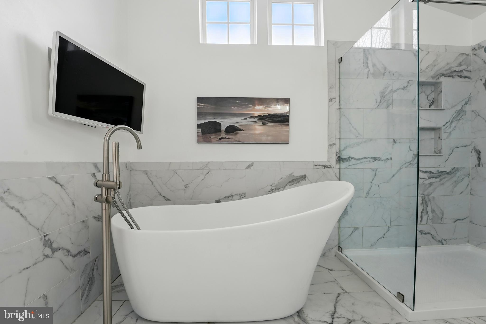 6712 Eldermill Lane Gainesville, VA 20155 - Photo 32 of 56 a white bath tub sitting in a bathroom
