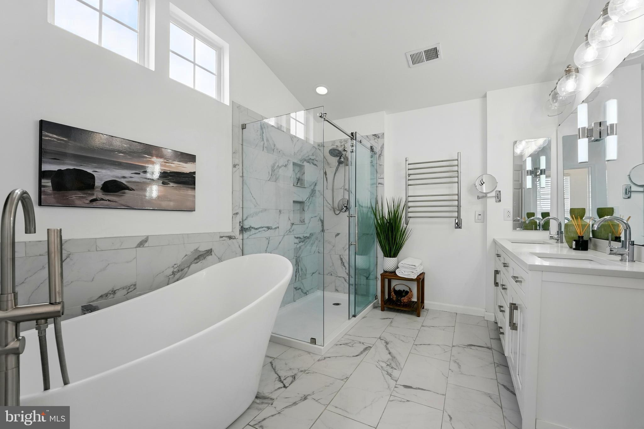 6712 Eldermill Lane Gainesville, VA 20155 - Photo 33 of 56 a bathroom with a tub a potted plant and a sink