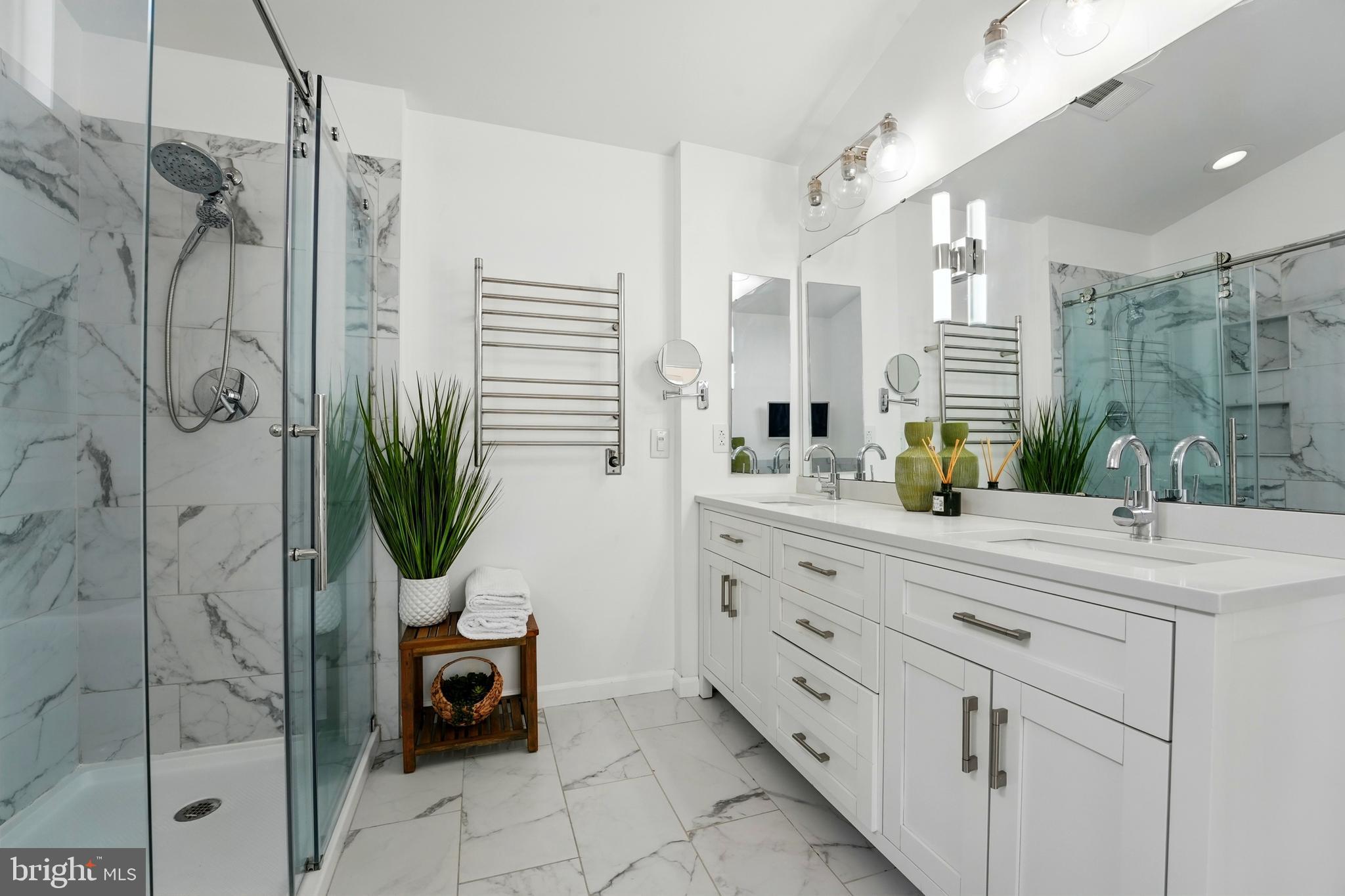 6712 Eldermill Lane Gainesville, VA 20155 - Photo 34 of 56 a spacious bathroom with a shower sink and mirror