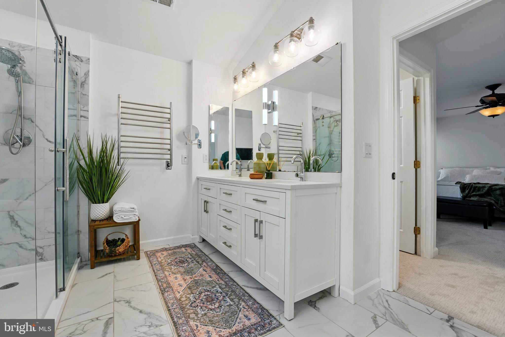6712 Eldermill Lane Gainesville, VA 20155 - Photo 35 of 56 a bathroom with a double vanity sink a mirror and a shower
