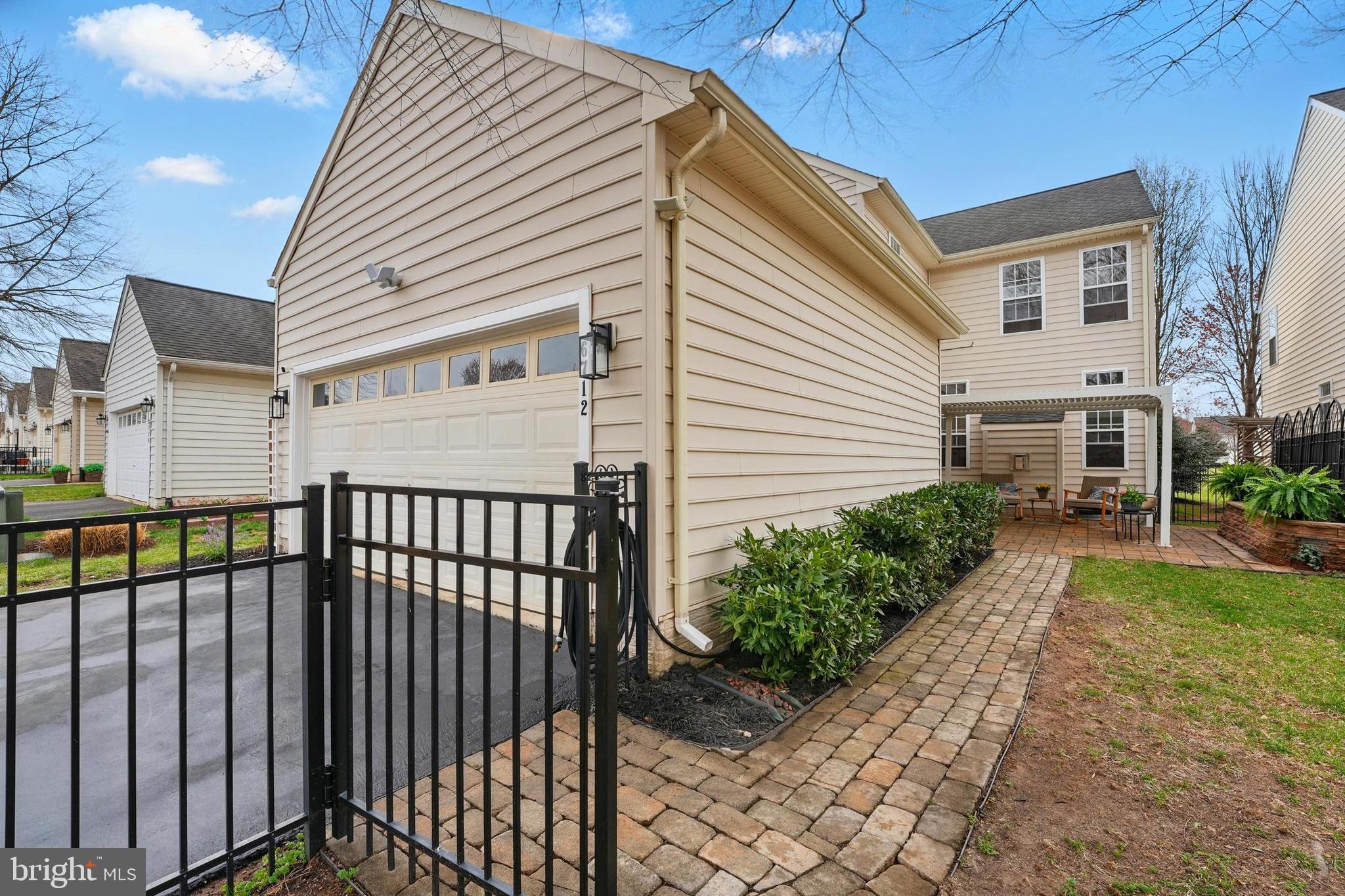6712 Eldermill Lane Gainesville, VA 20155 - Photo 43 of 56 a view of a white house with a small yard and a large window
