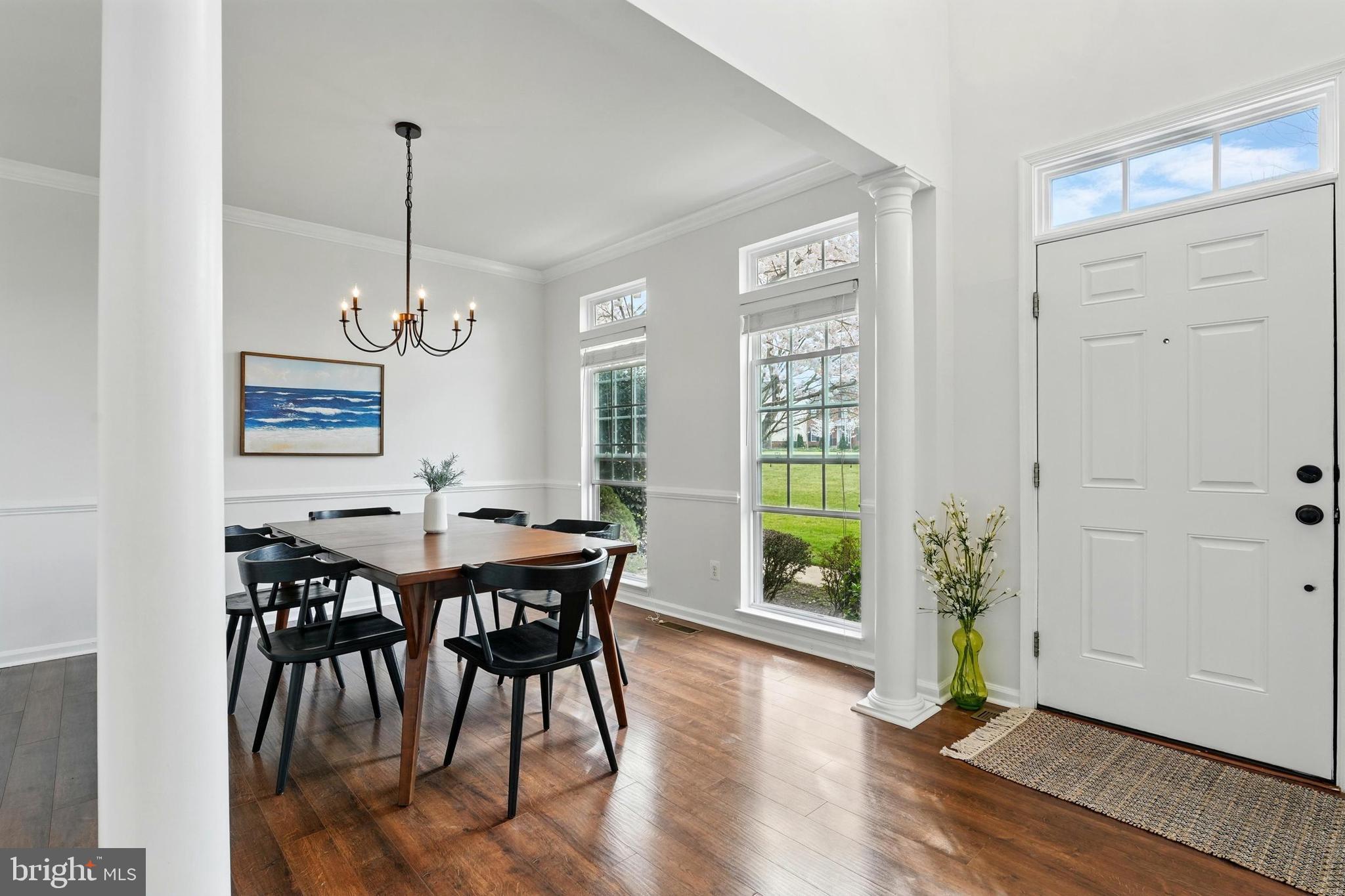 6712 Eldermill Lane Gainesville, VA 20155 - Photo 7 of 56 a view of a dining room with furniture window and wooden floor