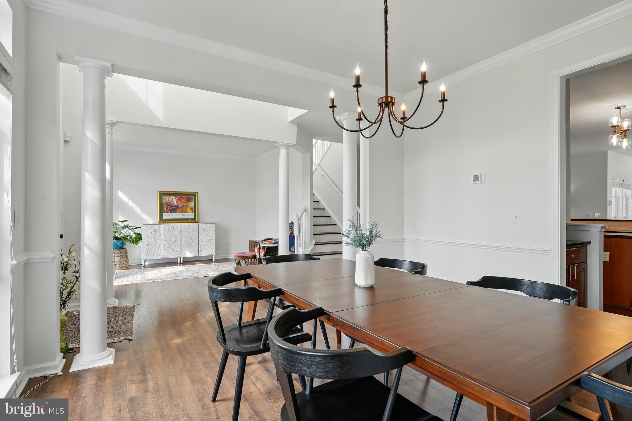 6712 Eldermill Lane Gainesville, VA 20155 - Photo 8 of 56 a view of a dining room with furniture and wooden floor