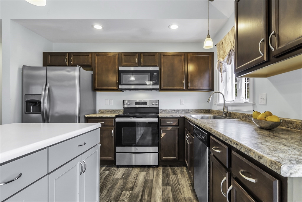 1 Lois Lane Townsend, MA 01469 - Photo 11 of 38 a kitchen with stainless steel appliances granite countertop a sink stove and refrigerator