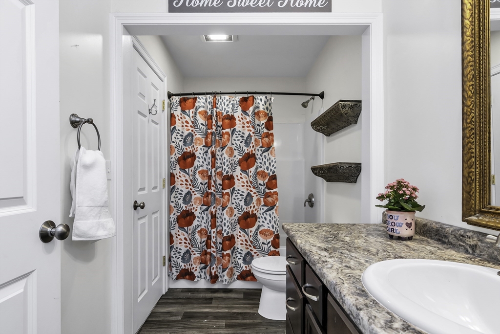 1 Lois Lane Townsend, MA 01469 - Photo 18 of 38 a bathroom with a granite countertop sink a mirror and shower curtain