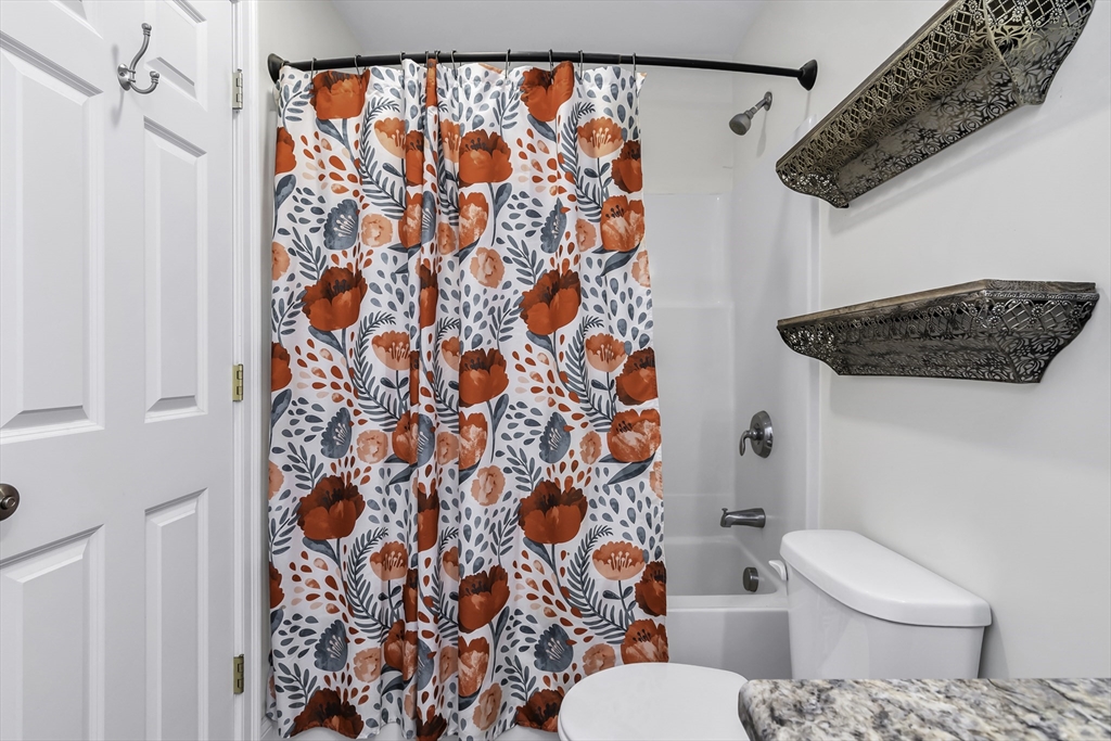 1 Lois Lane Townsend, MA 01469 - Photo 19 of 38 a white toilet sitting next to a shower curtain