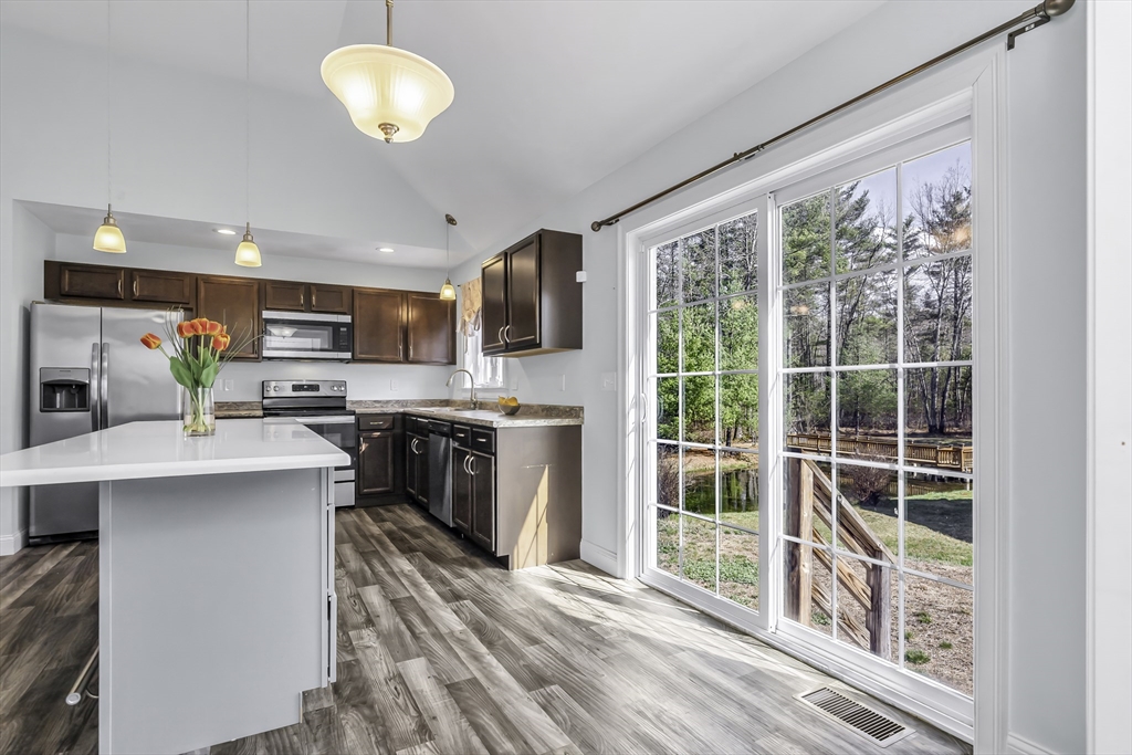 1 Lois Lane Townsend, MA 01469 - Photo 10 of 38 a kitchen with kitchen island granite countertop a stove a sink and a refrigerator