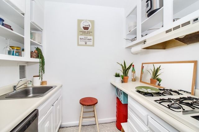 a kitchen with stainless steel appliances a stove a sink and a refrigerator