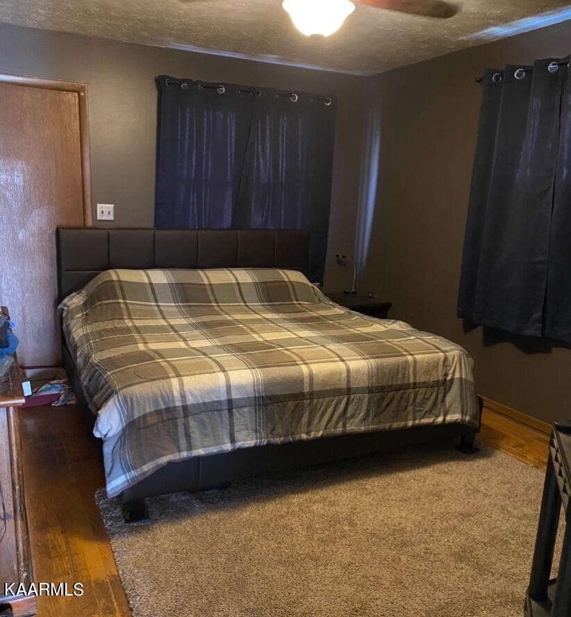 959 Fox Hunter Road Maynardville, TN 37807 - Photo 13 of 17 a bed sitting in a bedroom next to a wooden door