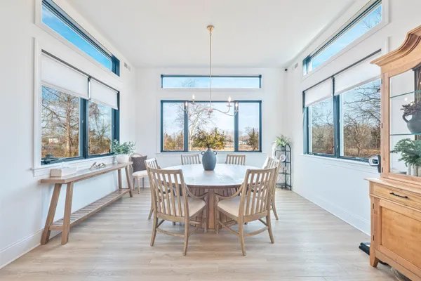 a view of a dining room with furniture window and wooden floor