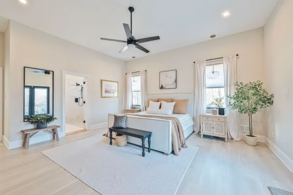a bedroom with a large bed and a chandelier