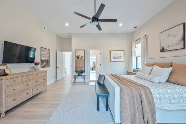 a bedroom with a large bed and a flat screen tv