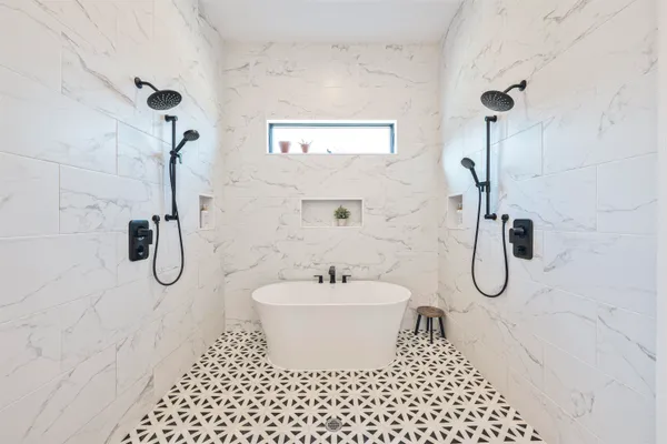 a bathroom with a granite countertop shower and a sink