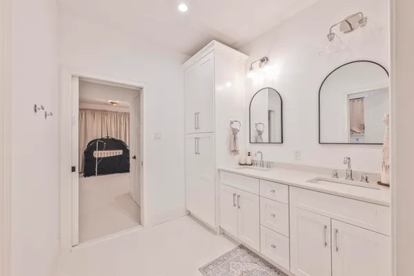 a bathroom with a double vanity sink and mirror