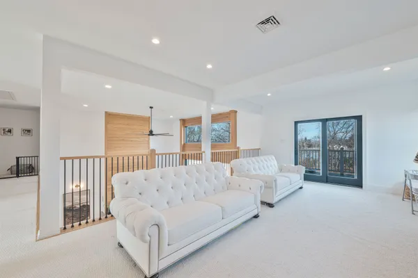 a spacious bedroom with a large bed and a large window