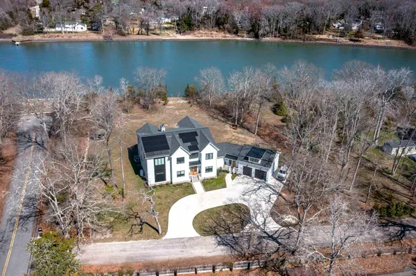 an aerial view of a house with a lake view