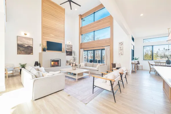 a living room with furniture a fireplace and a large window