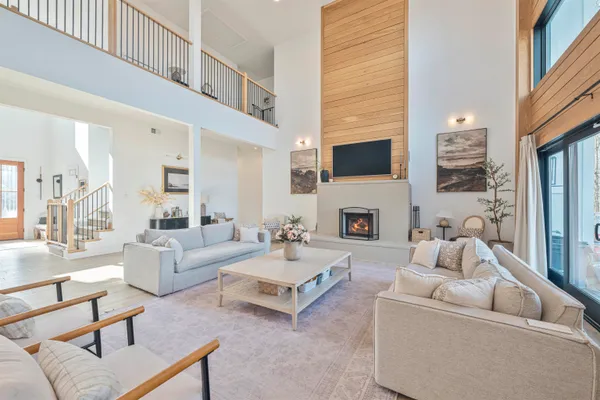 a living room with furniture a fireplace and a flat screen tv