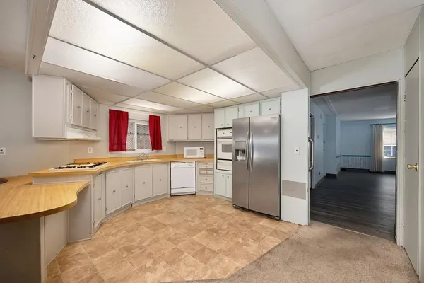 a kitchen with refrigerator and cabinets