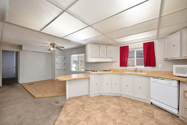 a kitchen with cabinets and stainless steel appliances