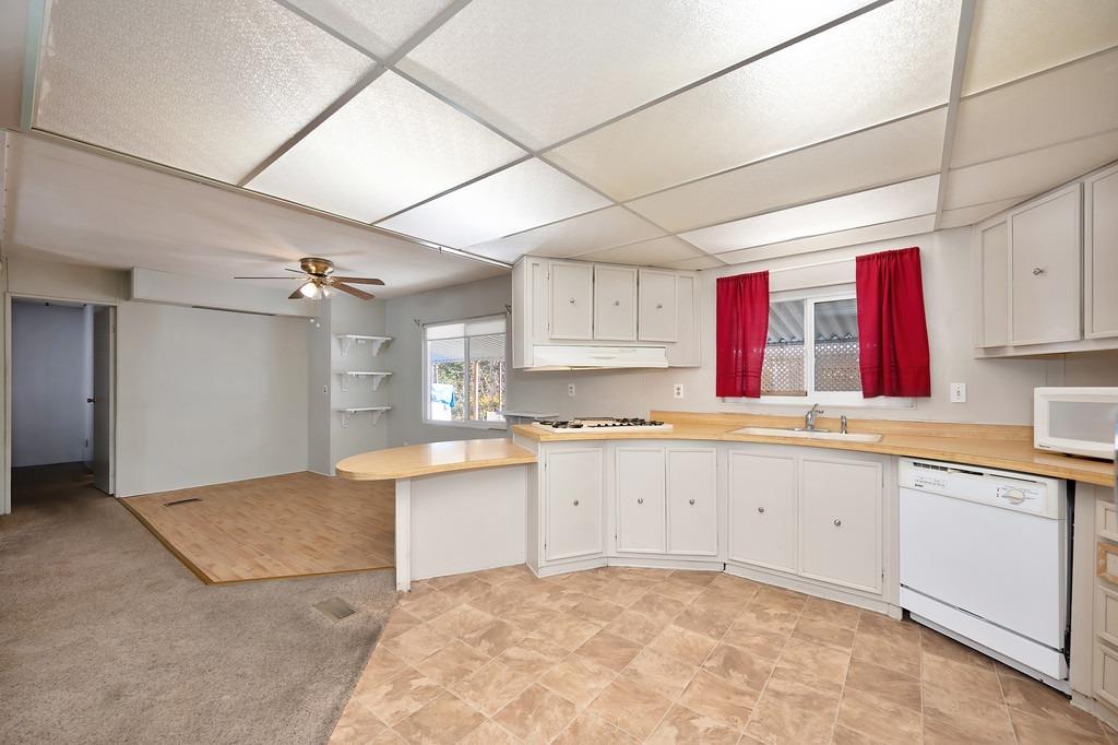 2874 Hidden Springs Circle Placerville, CA 95667 - Photo 23 of 41 a large kitchen with granite countertop a sink and white cabinets