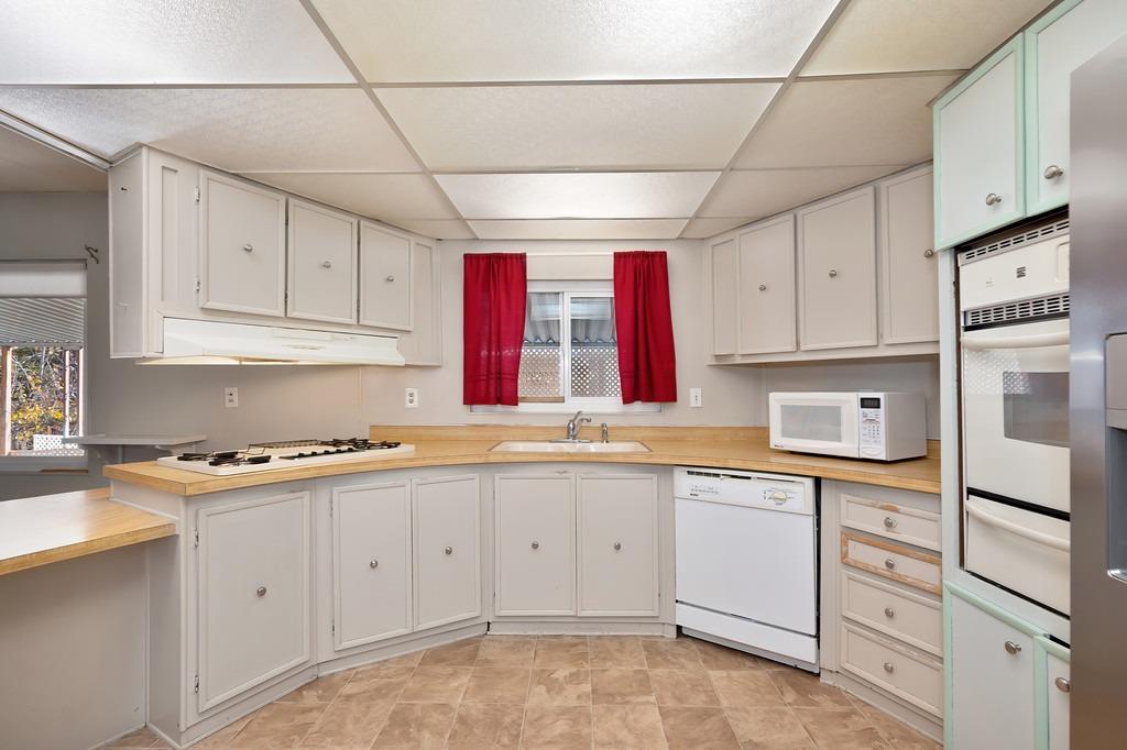 2874 Hidden Springs Circle Placerville, CA 95667 - Photo 24 of 41 a kitchen with cabinets appliances and a sink