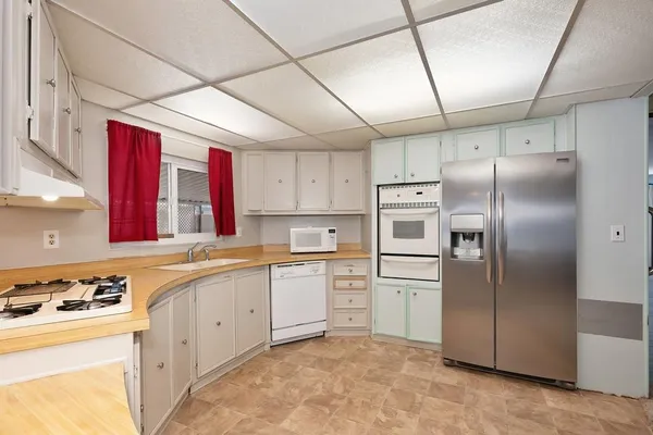 a kitchen with a sink a stove and cabinets