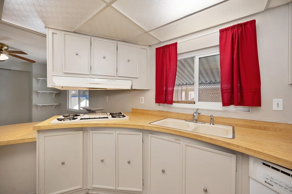 2874 Hidden Springs Circle Placerville, CA 95667 - Photo 27 of 41 a kitchen with a sink a stove and cabinets