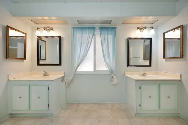 a view of a bathroom with sink and mirror