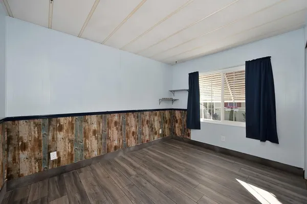 a view of wooden floor and windows in a room