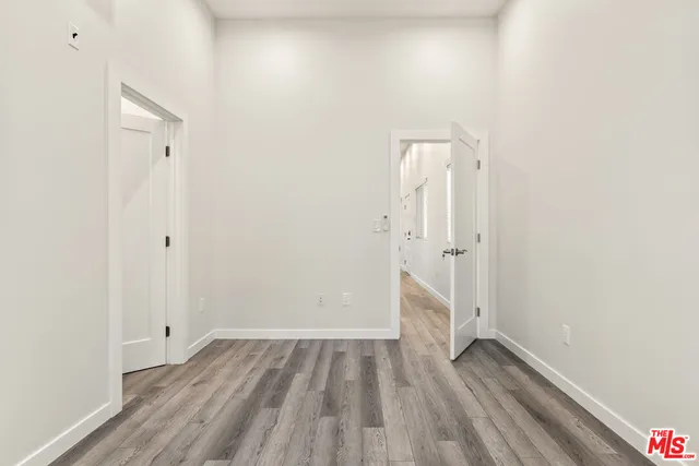a view of room with wooden floor and white walls