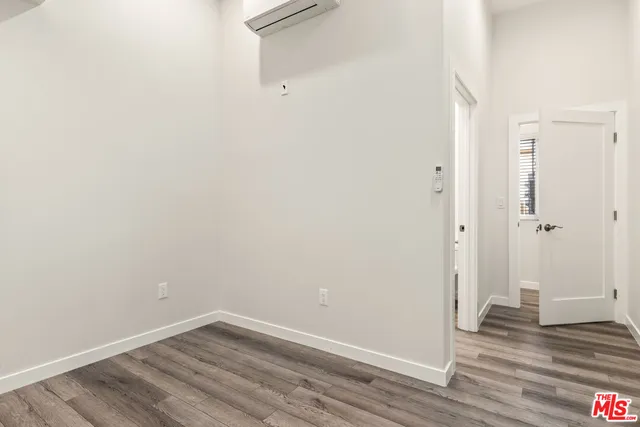 a view of a room with wooden floor