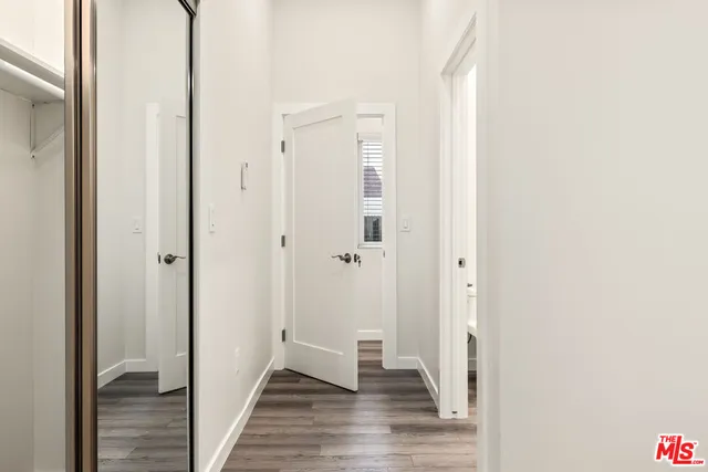 a view of a hallway with wooden floor