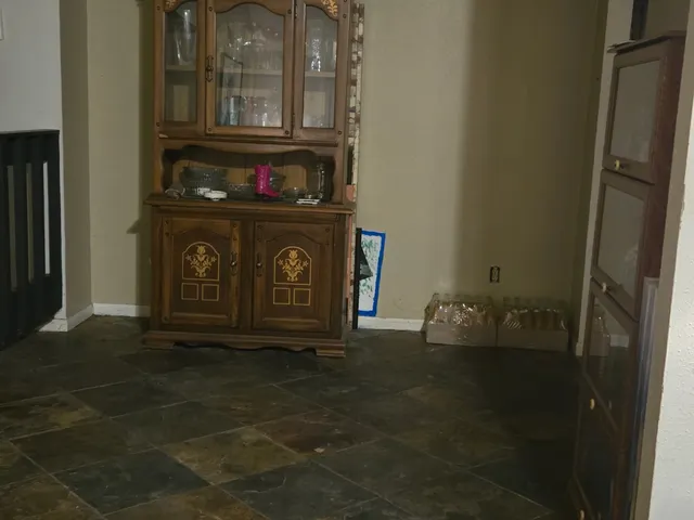 a bathroom with a granite countertop sink a toilet and mirror