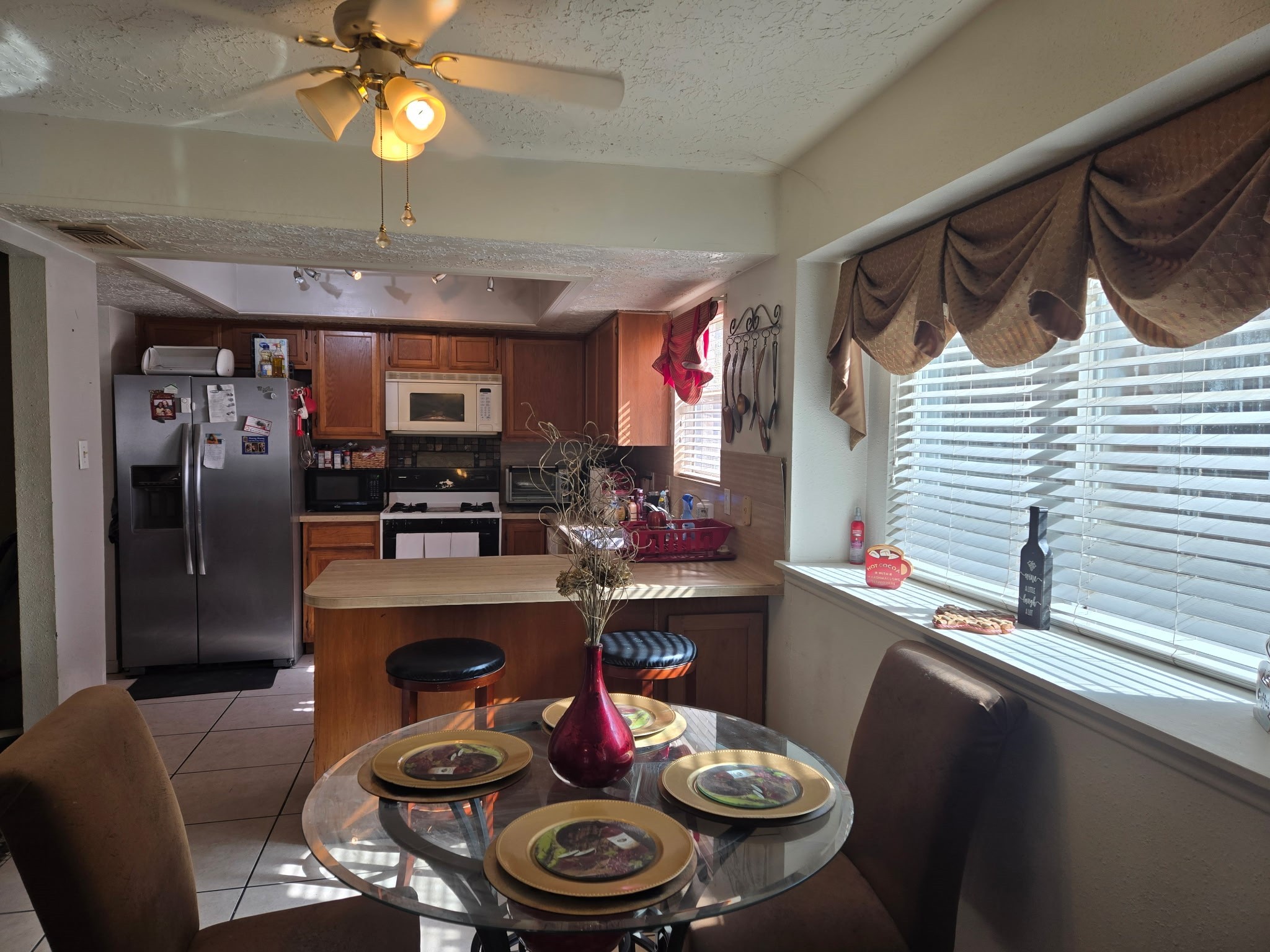 11615 Stone Bridge Drive Houston, TX 77064 - Photo 5 of 14 a kitchen with a dining table and chairs