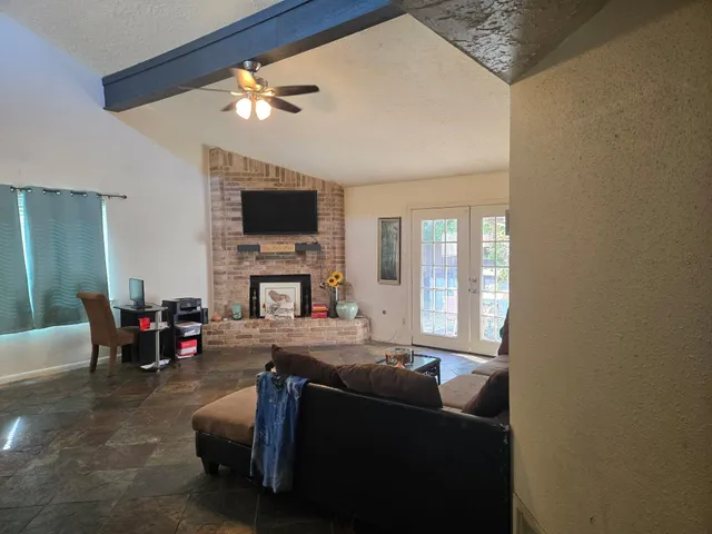 a backyard of a house with table and chairs