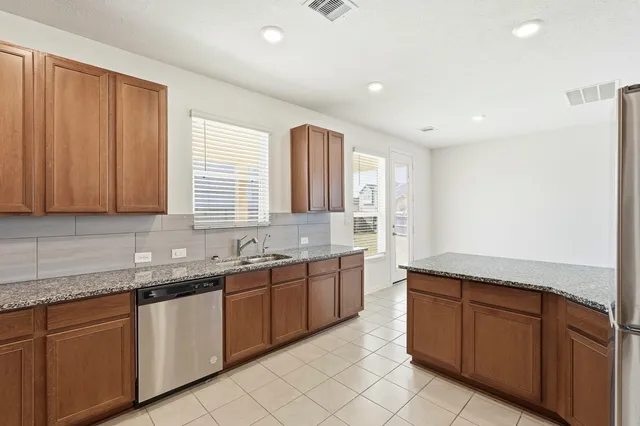 a kitchen with sink and cabinets